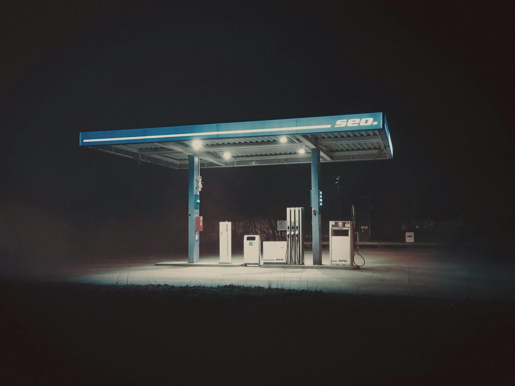 a gas station at night with a sign that says gas