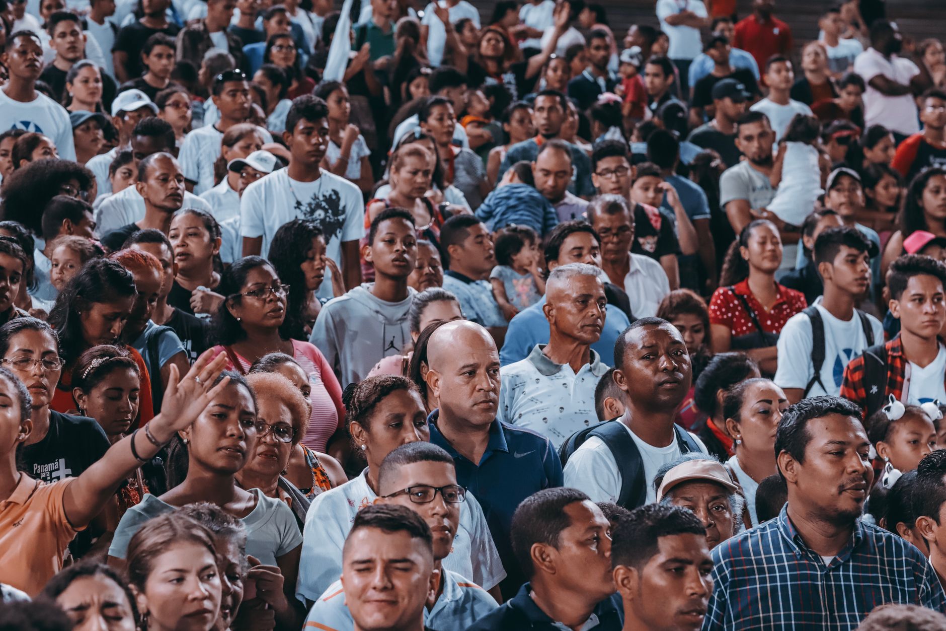 a crowd of people in religious gathering