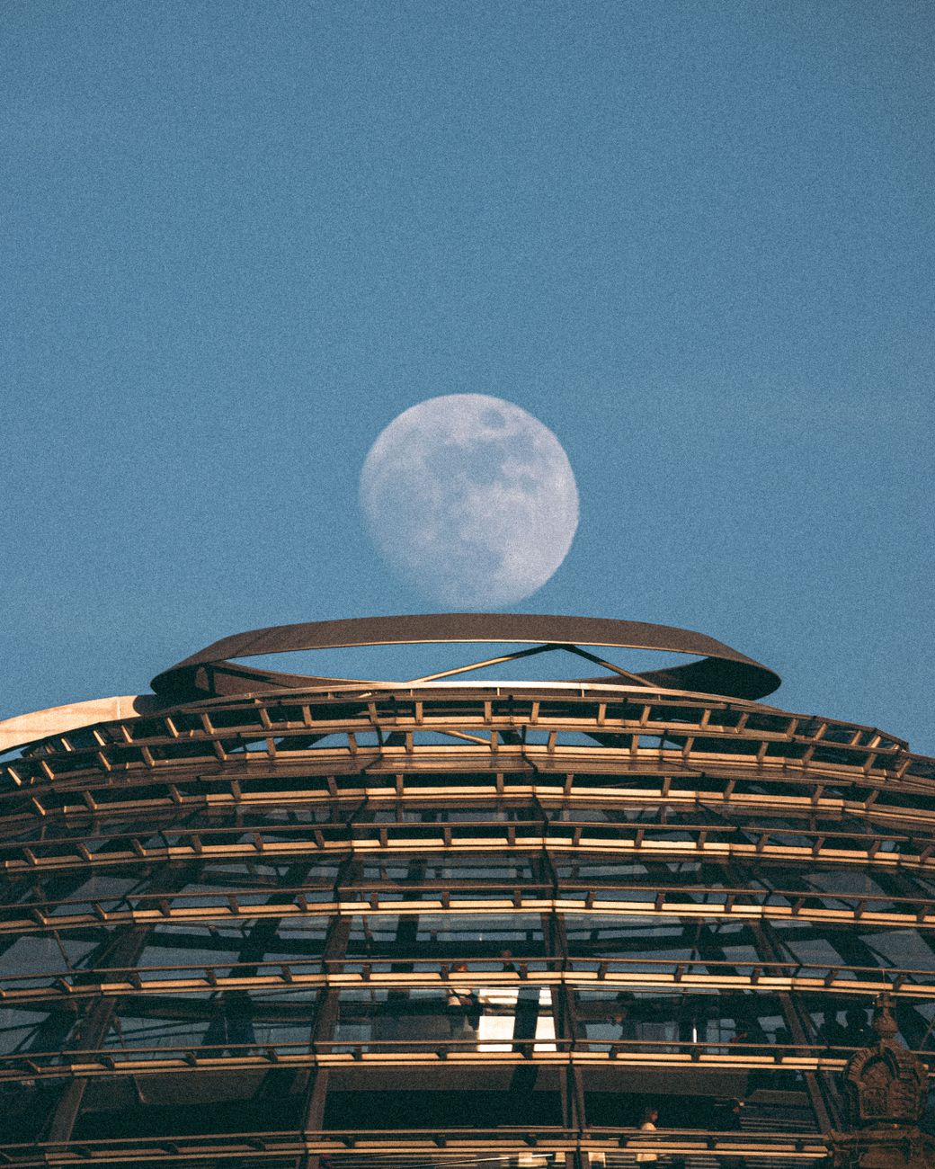 moon rising over berlin reichstag dome